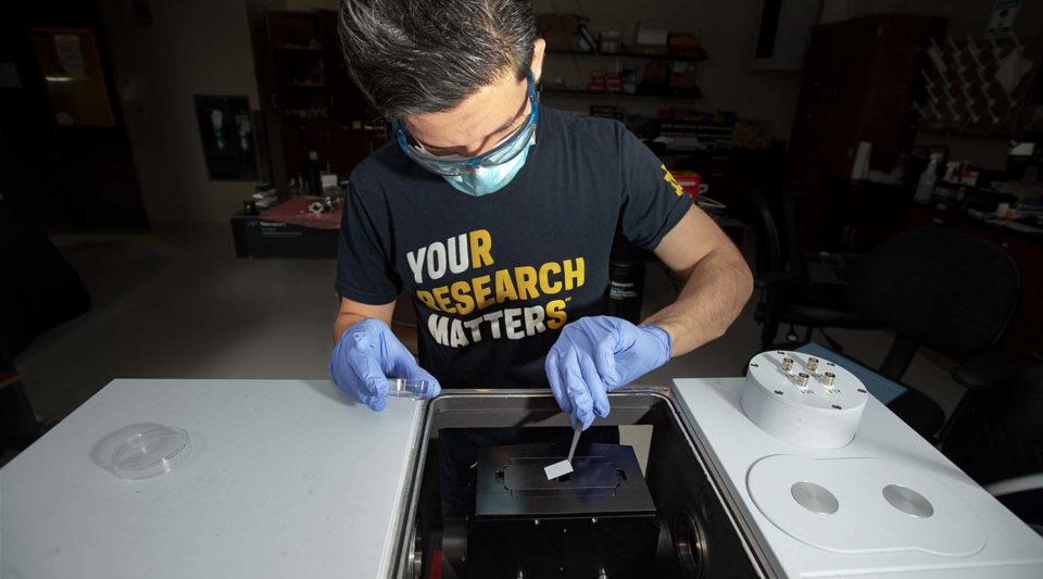 Electrical Engineering Ph.D. student Irfan Khan working in Professor Anthony Hoffman's Photonics Lab